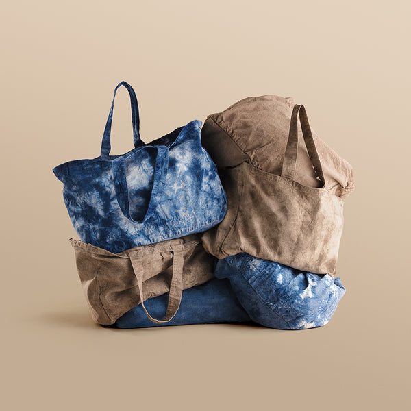 Heavy duty carryall bags in shibori dyed natural indigo and shibori dyed umber
