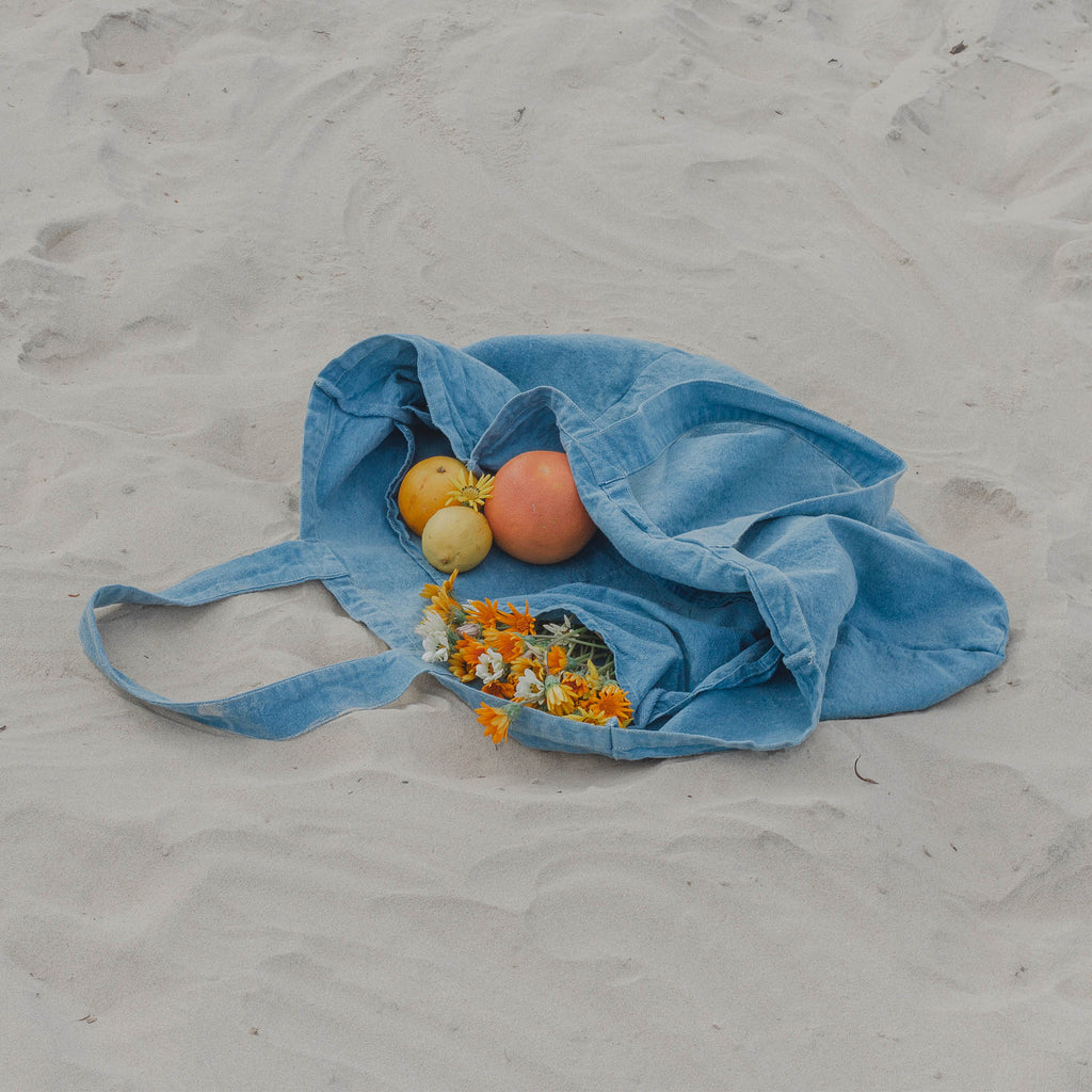 Repose indigo carryall bag at the beach